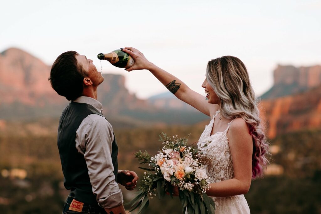 photo of bride and groom drinking champagne